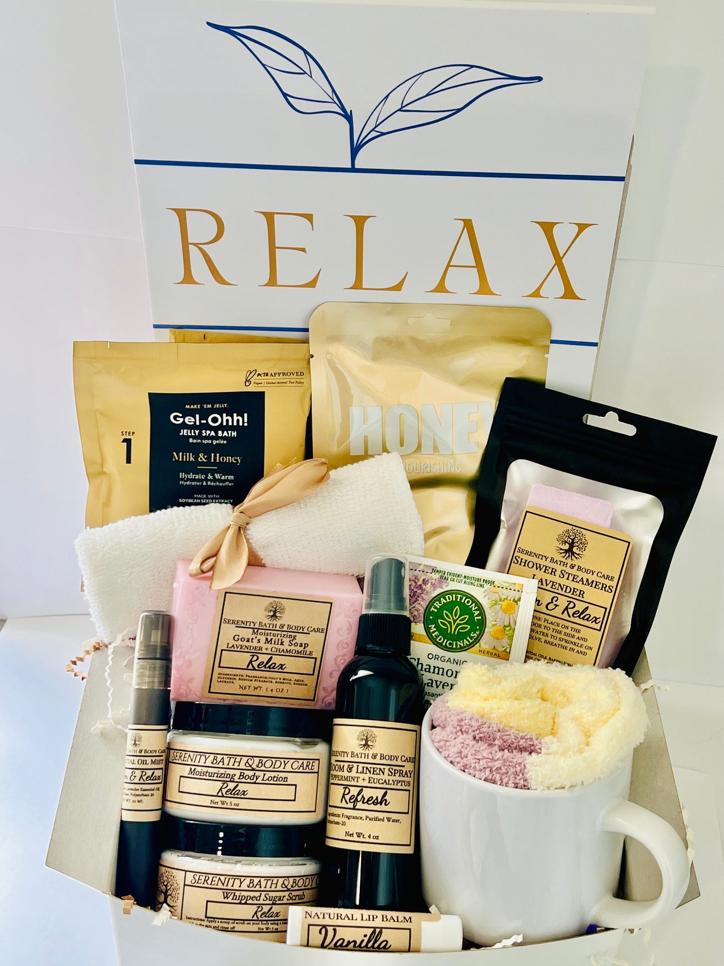 Luxury spa gift box for women with lavender, honey, and chamomile bath products, candle, lotion, tea, cozy socks, and mug in a white “Relax” box — perfect birthday, Christmas, or self-care gift.