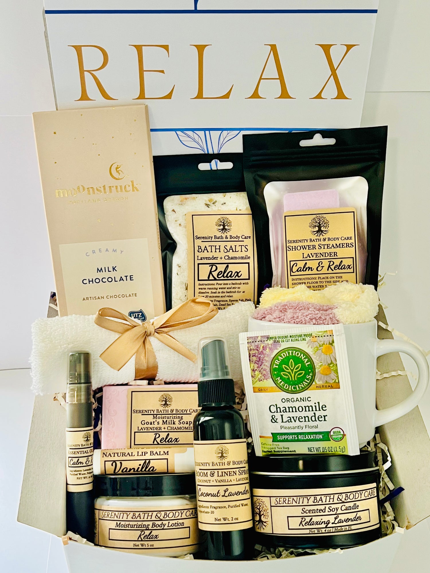 Luxury spa gift box for women with lavender and chamomile bath salts, soap, lotion, candle, tea, chocolate, cozy socks, and mug in a white “Relax” gift box. Perfect for birthdays, Christmas, or self-care gifting.