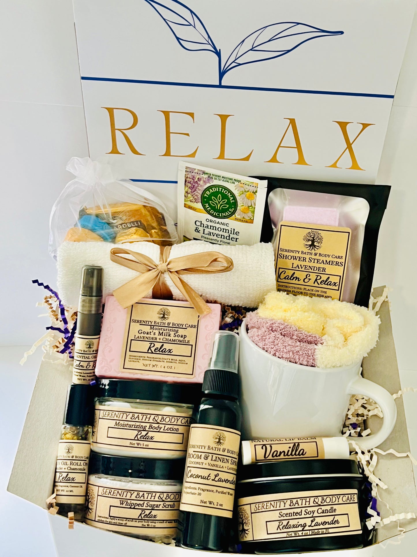 Luxury lavender spa gift box for women with bath salts, soap, lotion, candle, tea, cozy socks, and mug in a white “Relax” box — perfect self-care, birthday, or holiday gift.